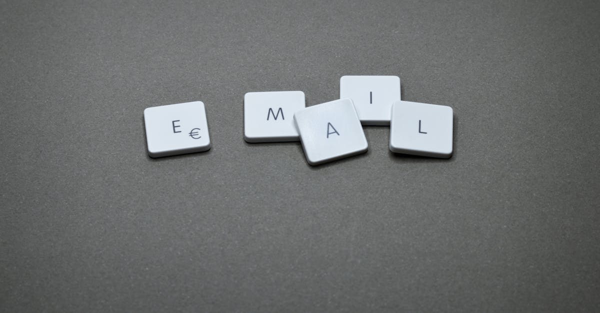 Close-up of the word 'email' formed with letter tiles on a gray surface.